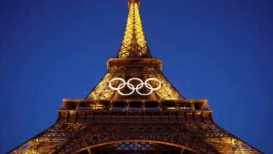 iffel tower lit candles pray olympic paris 2024